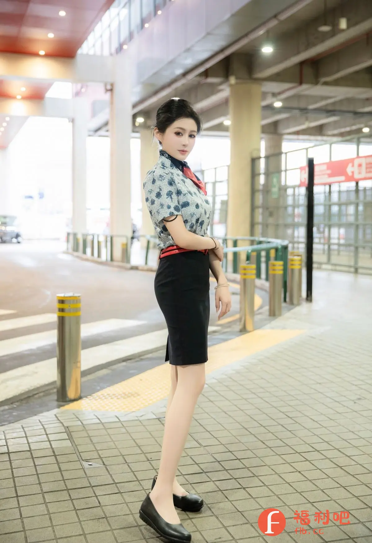 描述:照片中,一位年轻美丽的女性身着空姐制服,优雅地站在一个类似机场的通道里。她上半身穿着一件印有精致花纹的浅蓝色短袖衬衫,领口系着一条红色丝巾,腰间则系着一条鲜红色的腰带,勾勒出她的纤细腰身。下半身搭配一条及膝的黑色包臀裙,更显她的职业气质。她脚上穿着一双黑色平底皮鞋,舒适又干练。
她的头发整齐地盘起,露出精致的五官,眼神温柔而专注地看向镜头。她微微侧身,手臂自然地交叉在身前,姿态优雅而自信。背景是现代化的机场通道,柱子林立,光线充足,更衬托出她的美丽和专业形象。整体画面给人一种时尚、干练又不失温柔的感觉,展现了空姐的独特魅力。