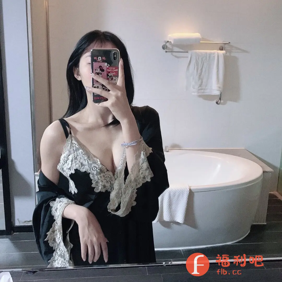 描述:这位美女身穿一套黑色蕾丝睡衣,在浴室里对着镜子自拍。睡衣的设计性感而精致,黑色丝绸面料搭配米白色蕾丝花边,更衬托出她白皙的皮肤。蕾丝在领口、袖口和裙摆处都有点缀,增添了浪漫的气息。她手持一部带有卡通图案的手机,遮住了面部,更显神秘感。浴室的背景简洁明亮,白色的浴缸和墙面营造出干净整洁的氛围。整体画面给人一种慵懒、性感又舒适的感觉,让人不禁想知道这套睡衣的品牌和购买渠道。作为买家秀,这无疑是一张极具吸引力的照片,能够激发潜在买家的购买欲望。睡衣的质感和款式都非常吸引人,相信会受到不少女性的喜爱。